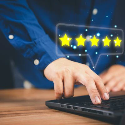 a person typing a 5 star review on a laptop. See what our customers have to say about Exclusive Cleaning summit's handyman services in Summit County, CO